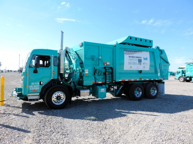 A Teal Garbage Collection Truck